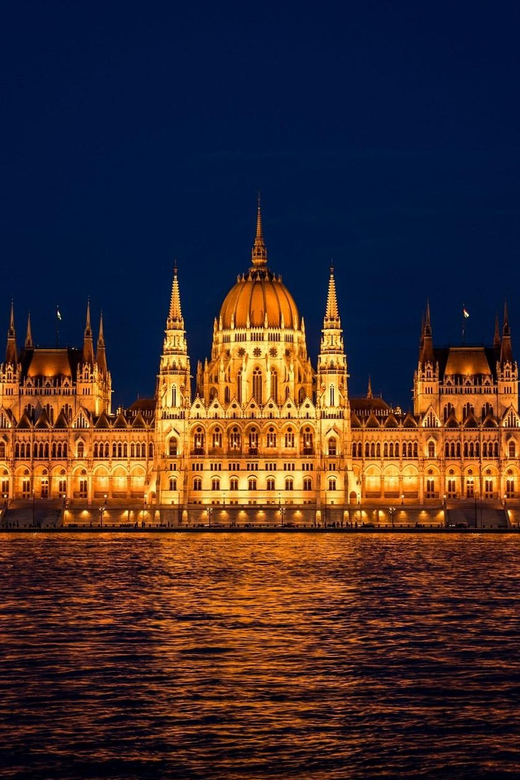 The Hungarian Parliament floodlit above the Danube at night